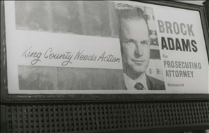 Black and white billboard with a white man's face and text 